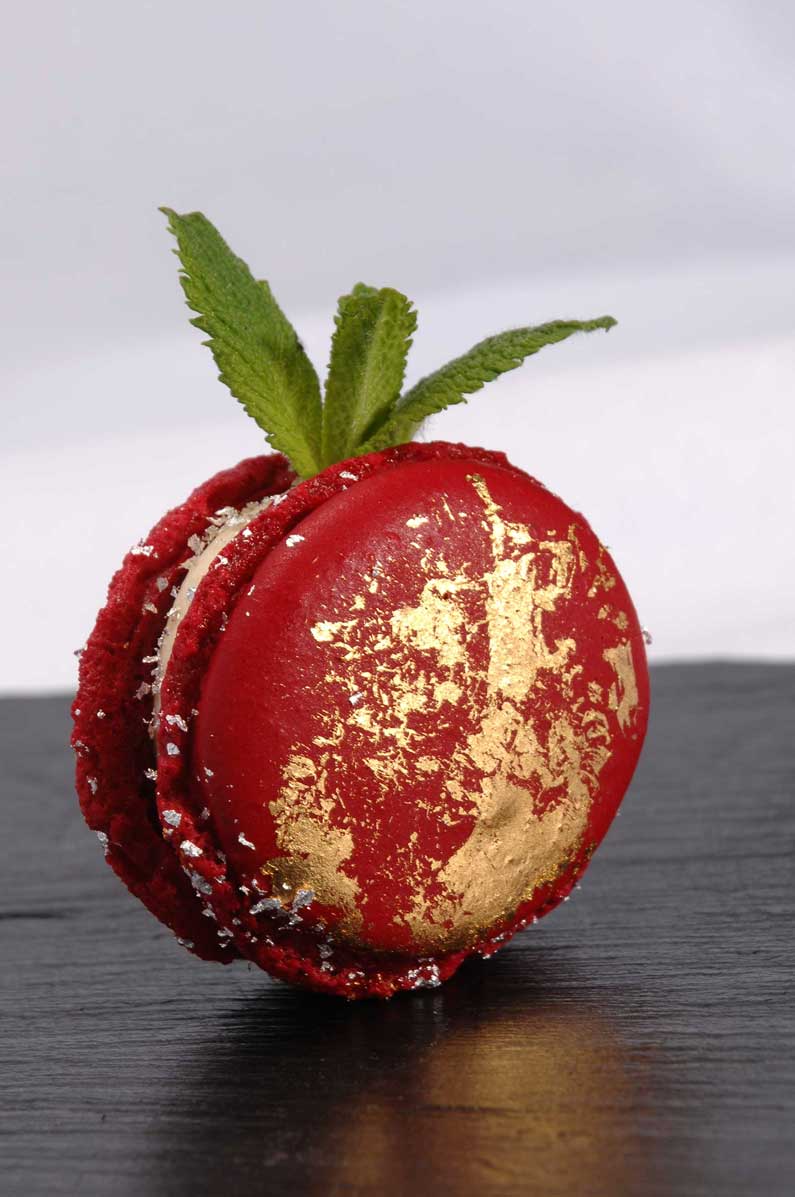Berry macaron with gold leaf and silver flakes